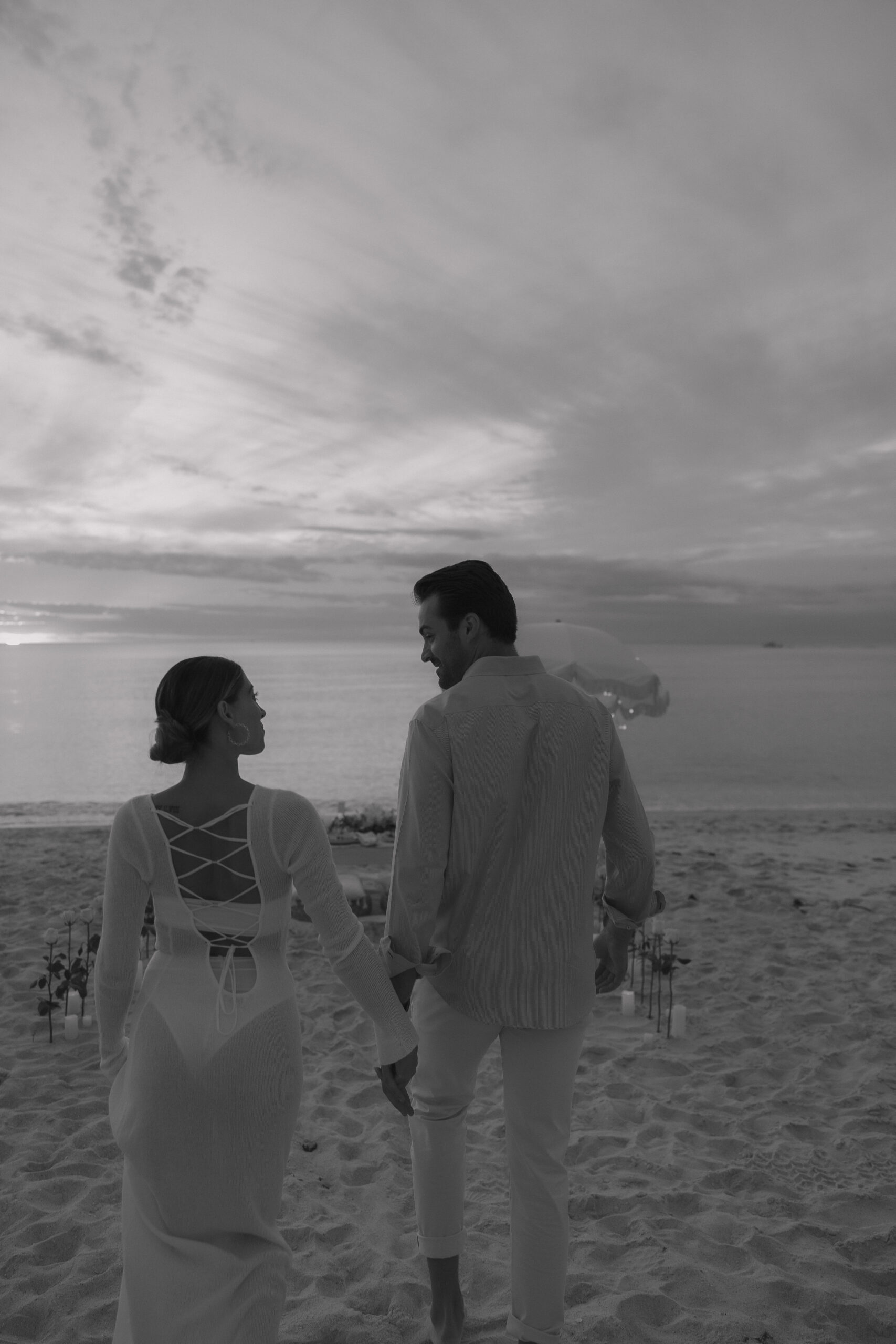 Black and white image on the naples beach at sunset after intimate proposal.