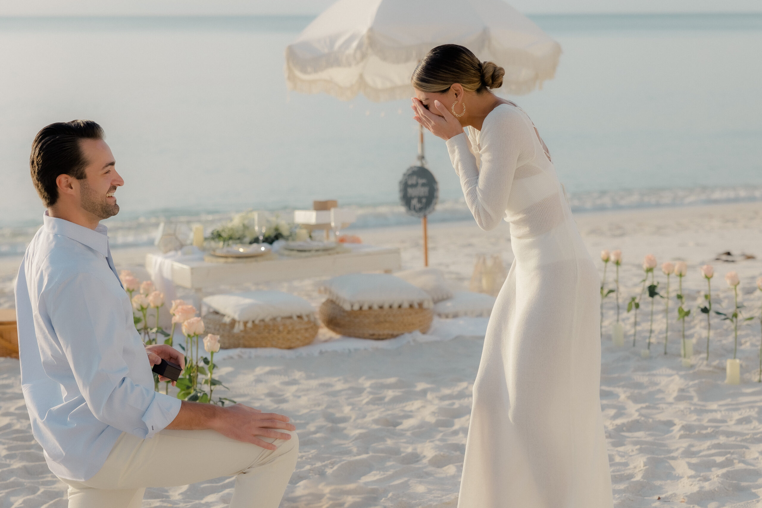 Emotional capture of the proposal moment by Maddie Briggs, a Naples, Florida photographer, showcasing the heartfelt exchange between Brandon and Nicole as he drops to one knee against the backdrop of Naples' scenic beauty.

