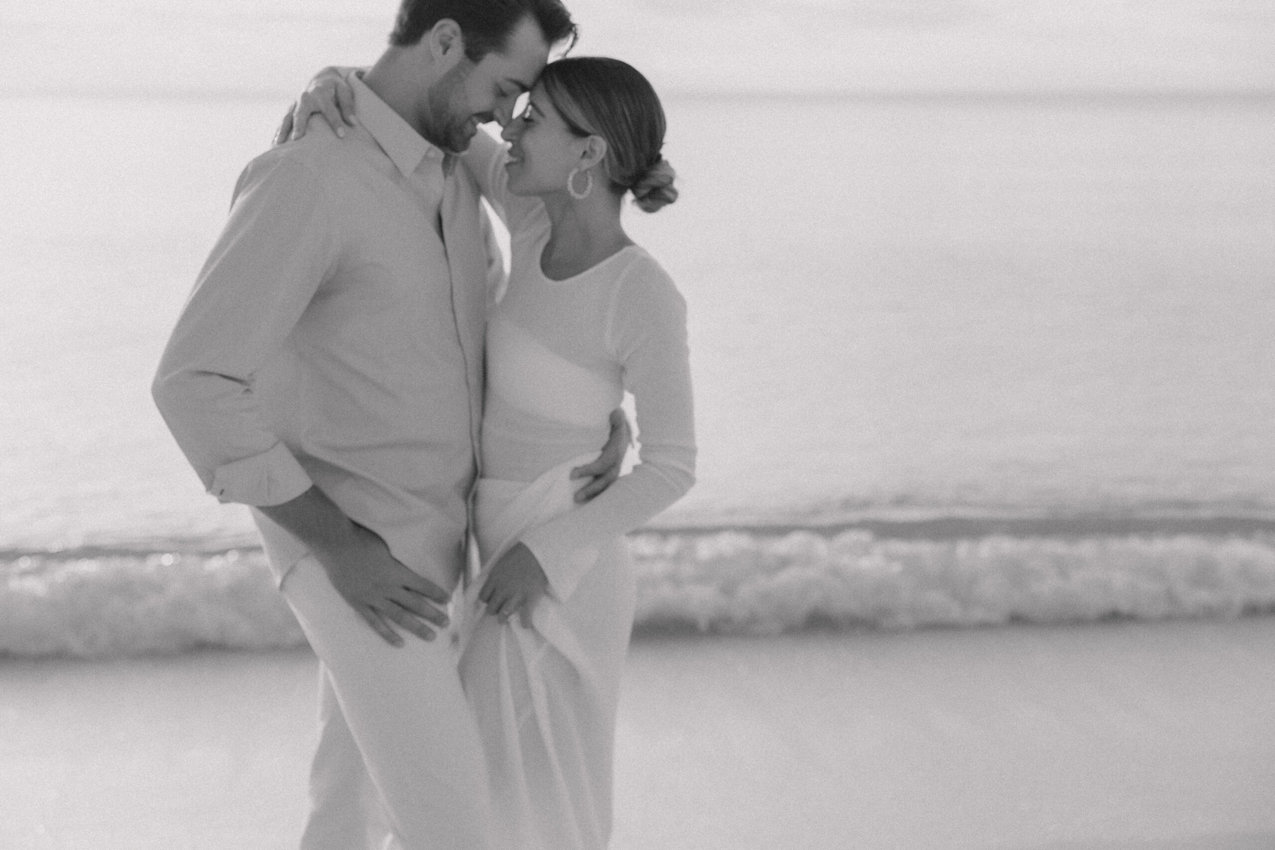 The engaged couple sharing a tender moment during their dreamy Naples proposal, captured by Maddie Briggs, a skilled photographer based in Naples, Florida.